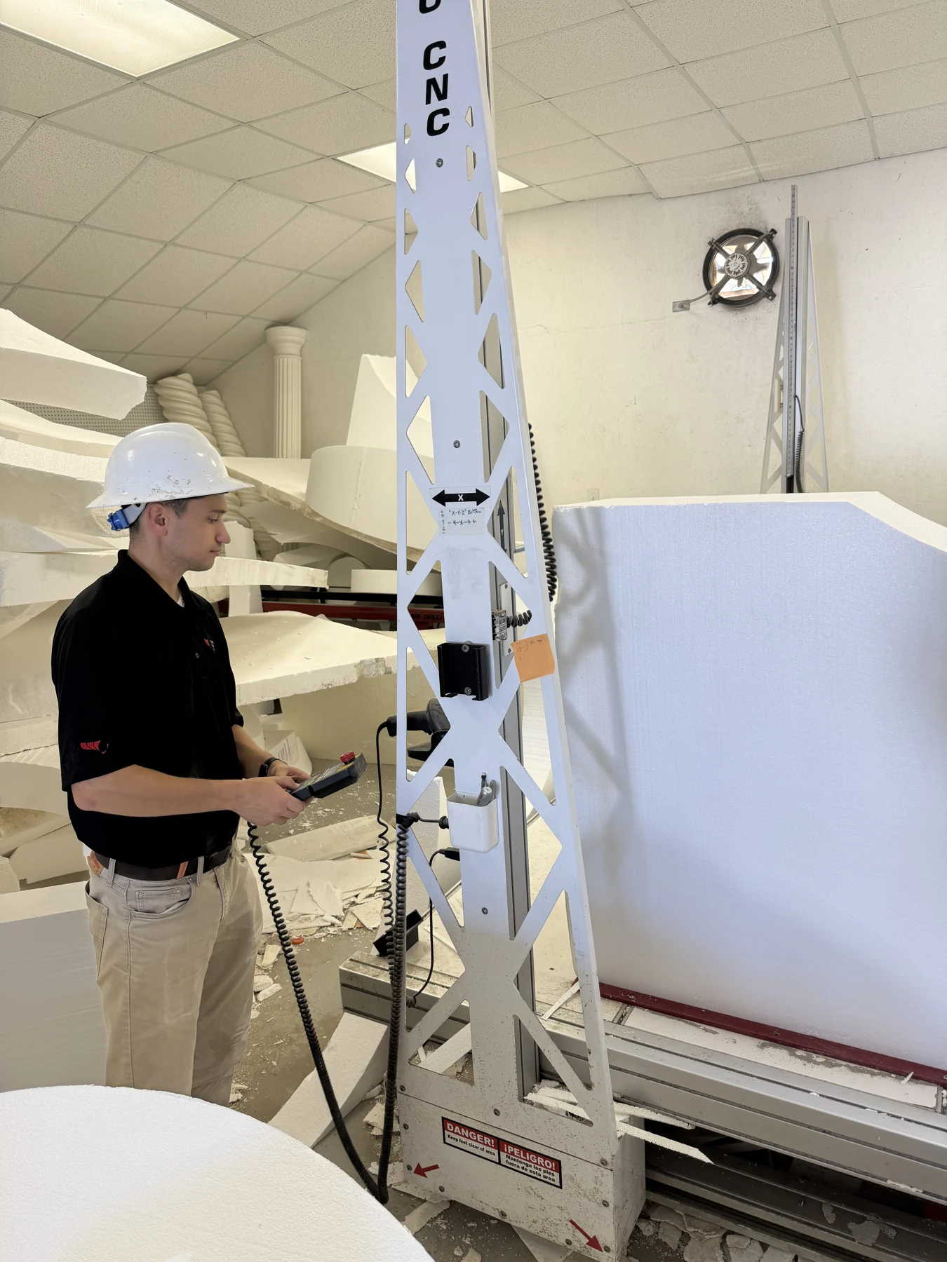 Operating the CNC machine beside a large foam block