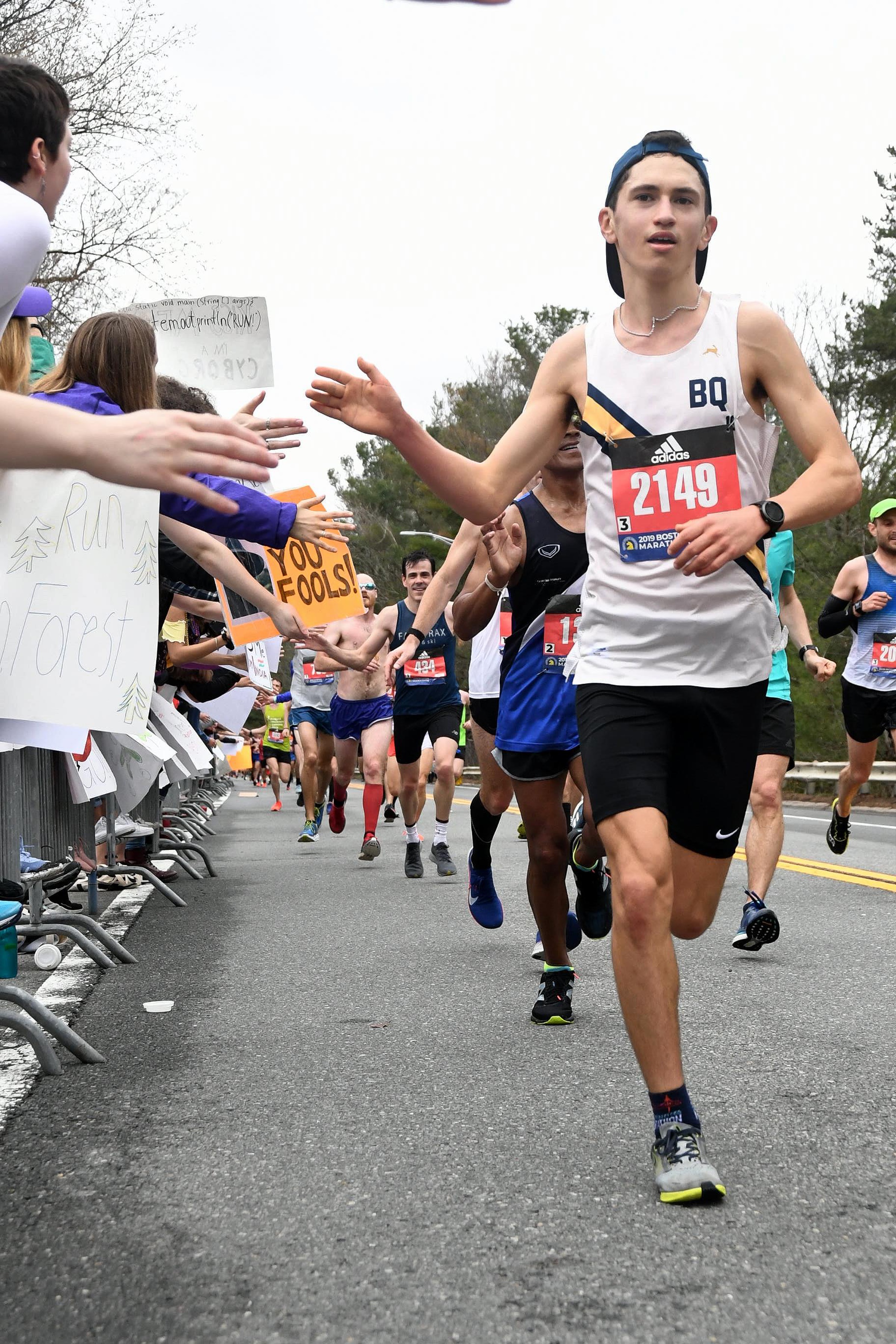 High-fiving spectators during the 2019 Boston Marathon